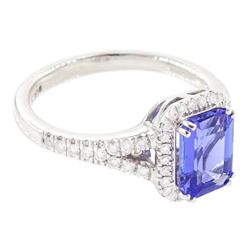 Platinum tanzanite and diamond cluster ring, single emerald cut tanzanite of approx 1.75 carat, with round brilliant cut diamond surround and split diamond set shoulders, signed Rhapsody, hallmarked, total diamond weight approx 0.20 carat