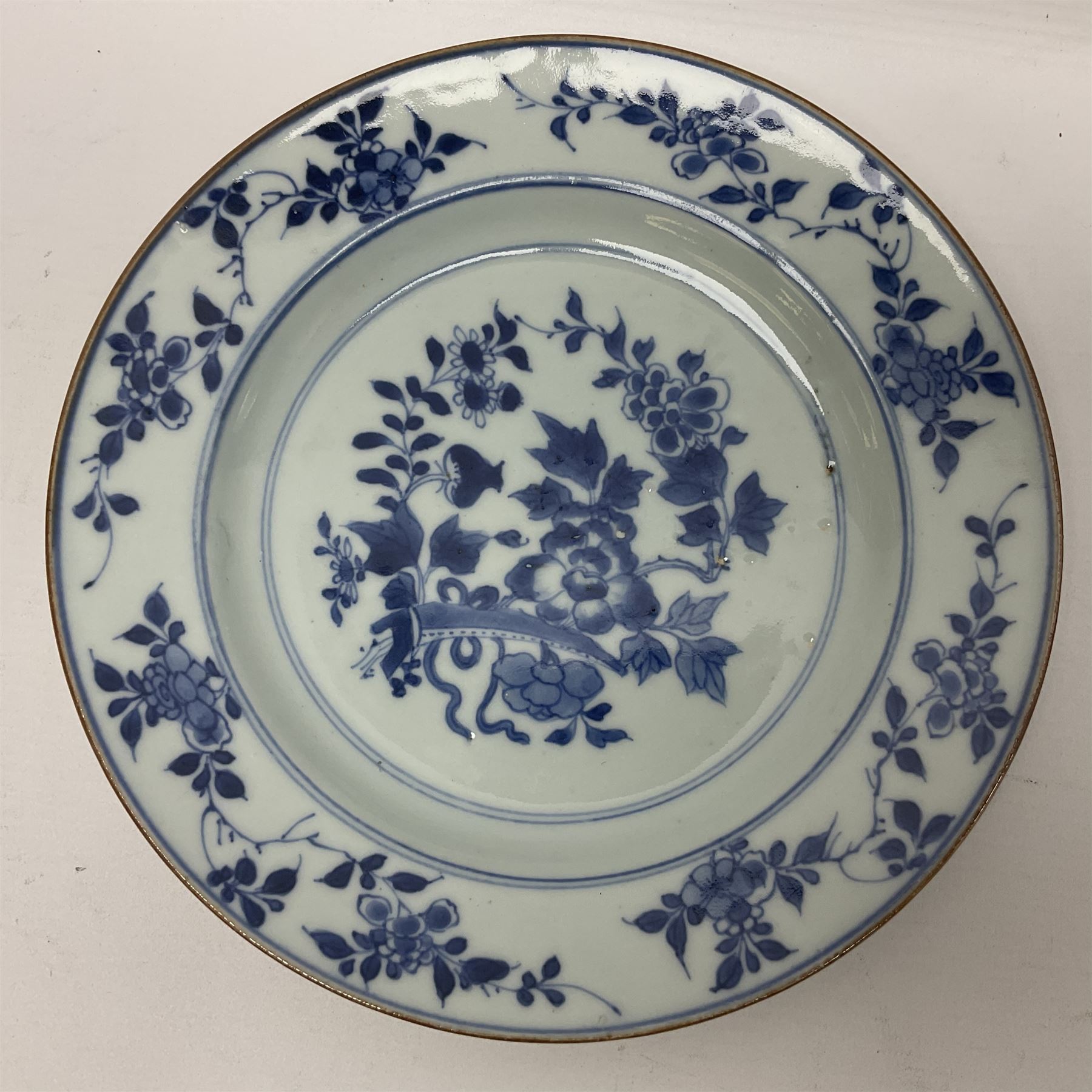 Japanese Meiji period Arita blue and white plate, of circular form, painted with riverside landscape and bird upon flowering branch, with character mark beneath, D24.5cm, together with two 18th century Chinese blue and white plates, each painted with floral design, each approximately D22.5cm