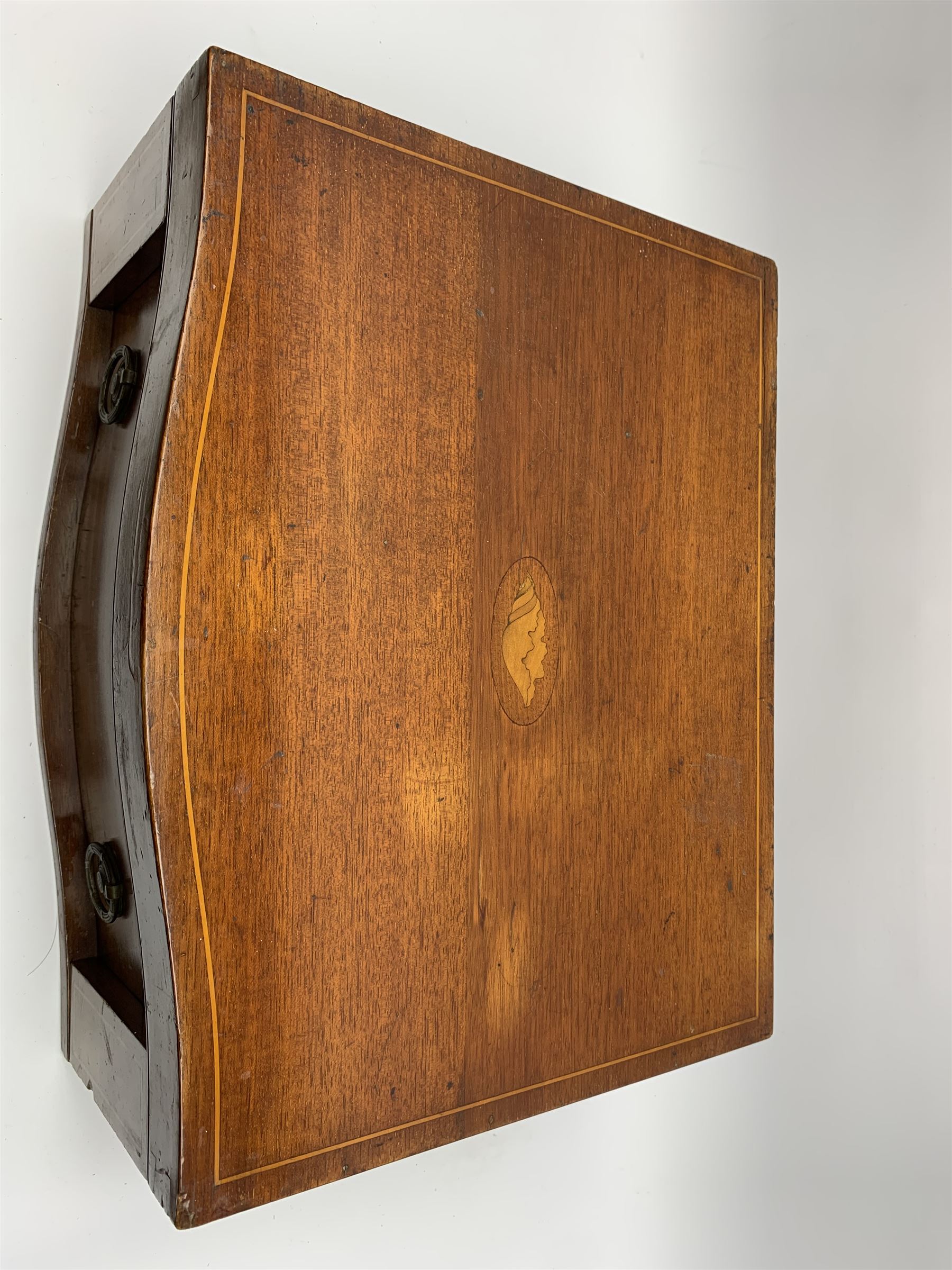 Late 19th/early 20th century composite canteen of silver flatware, contained within an early 20th century mahogany serpentine fronted case with twin drop carry handles, and hinged cover with boxwood stringing and central inlaid shell motif, above a single drawer with twin ring handles and Wellington style locking system, the cover and drawer opening to reveal plaque for Spink & Sons Ltd London, and fitted interior containing ivory handled knives, ivory handled carving set, and silver Hanoverian and Old English pattern cutlery, each with engraved monogram to terminal, hallmarked London, makers Spink & Son (John Marshall Spink), Goldsmiths & Silversmiths Co, and Chawner & Co (George William Adams), various dates ranging 1880-1923, gross weighable silver 92.59 ozt (2880 grams)