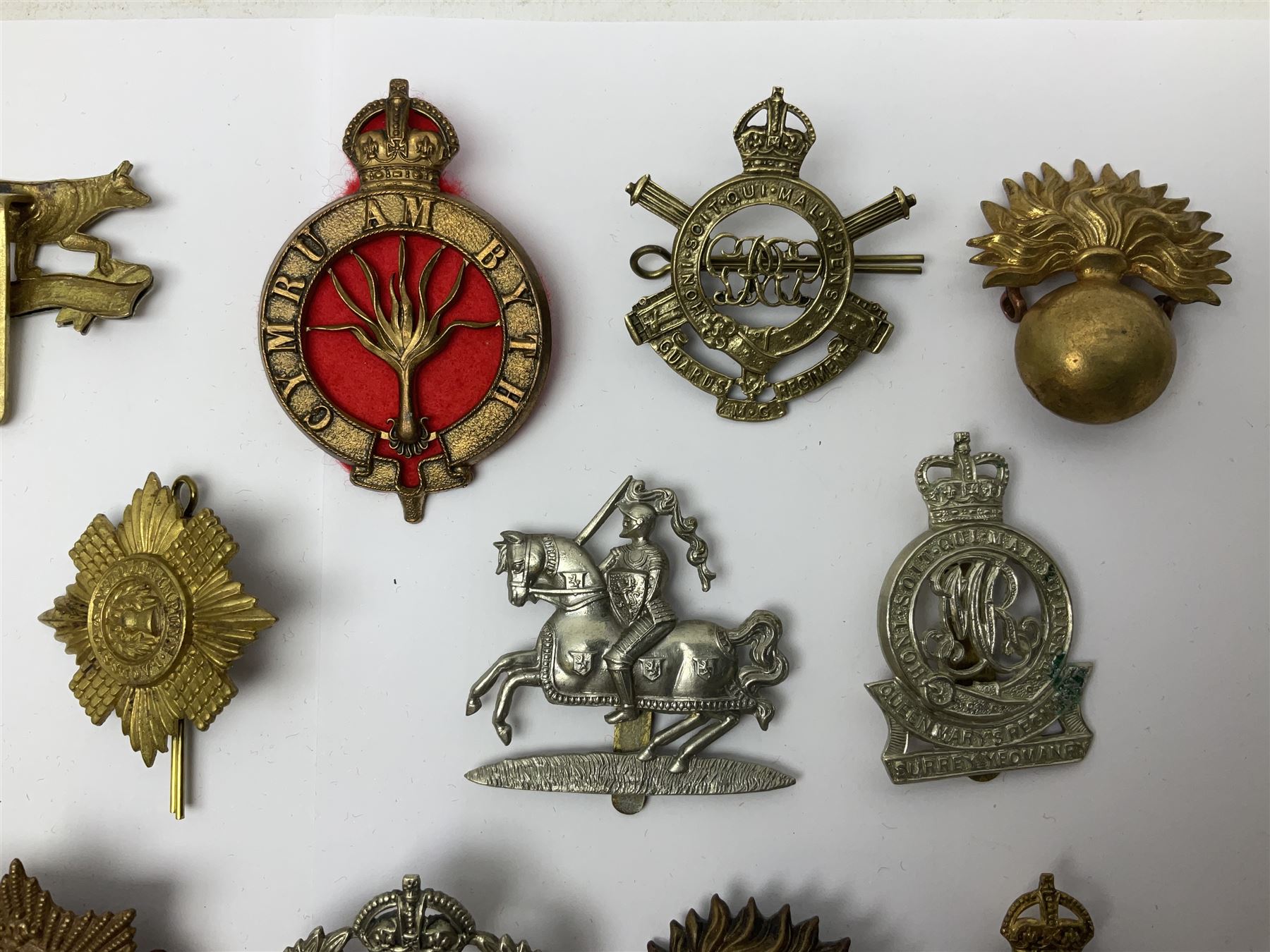 Twenty-six cap badges for Yeomanry and various guards including Fife & Forfar, Lothian and Border Horse, Leicestershire, Northamptonshire, Queens Own, Coldstream, Grenadier, Machine Gun Regiment, Life Guards etc (26)