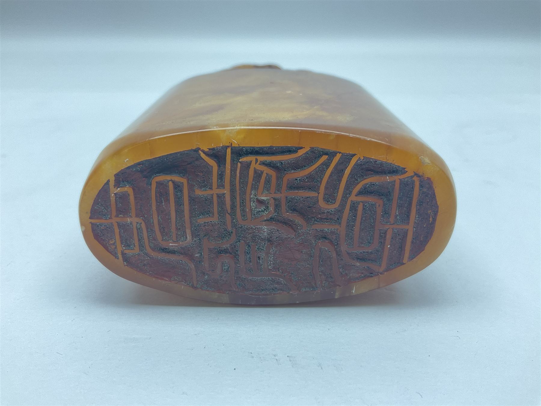 Chinese amber soapstone seal of oval form,  carved temple dog finial, inscription on the back and base, H12cm
