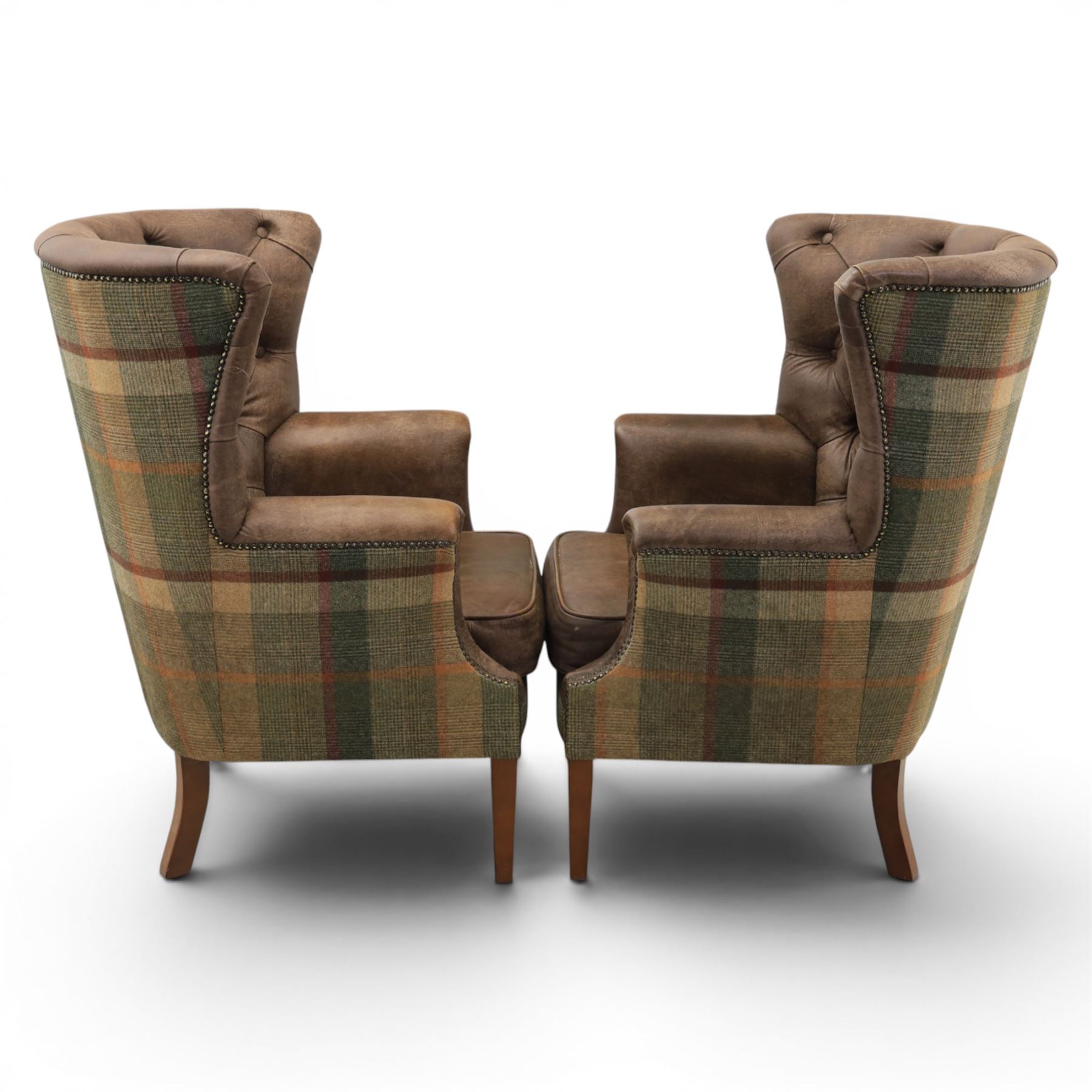 Pair of Georgian design wingback armchairs upholstered in brown leather and tartan tweed fabric, button back and scrolled arms with brass studded trim, square tapered supports