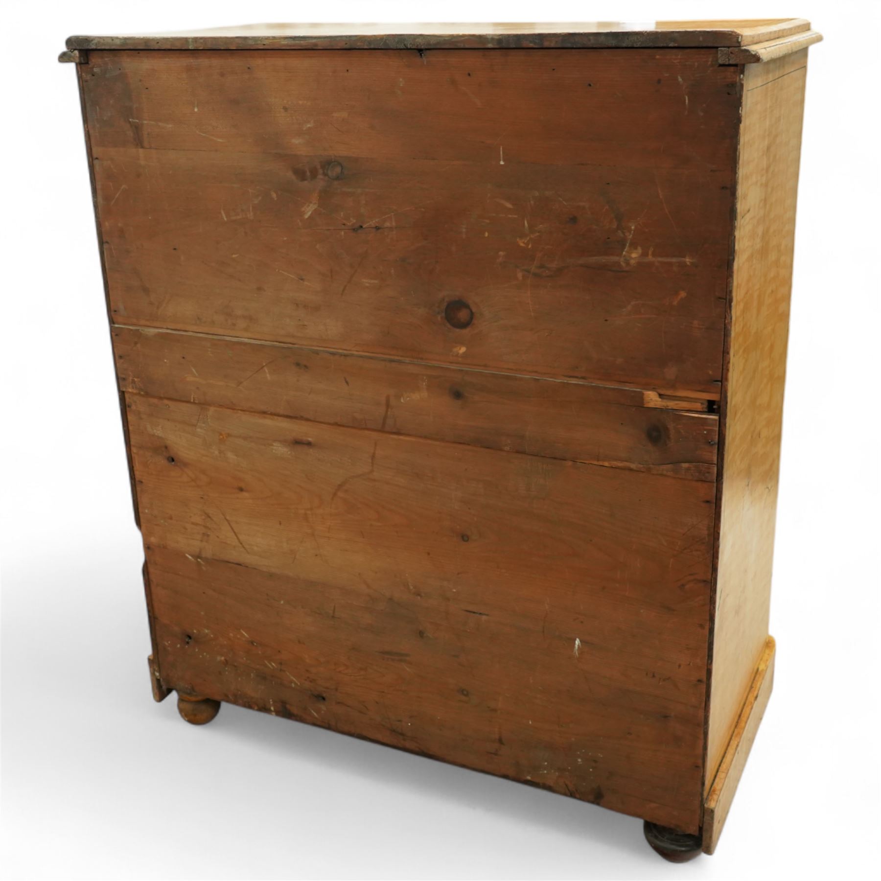 19th century pine painted chest of drawers, rectangular moulded top above two short and three graduated long drawers, each with painted foliate scroll and line detailing, turned knobs, and concealed turned feet, the sides with rounded corners and ebonised detail