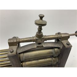 Victorian cuff and collar tabletop mangle, the ribbed brass rollers in a cast iron frame mounted on a wooden base