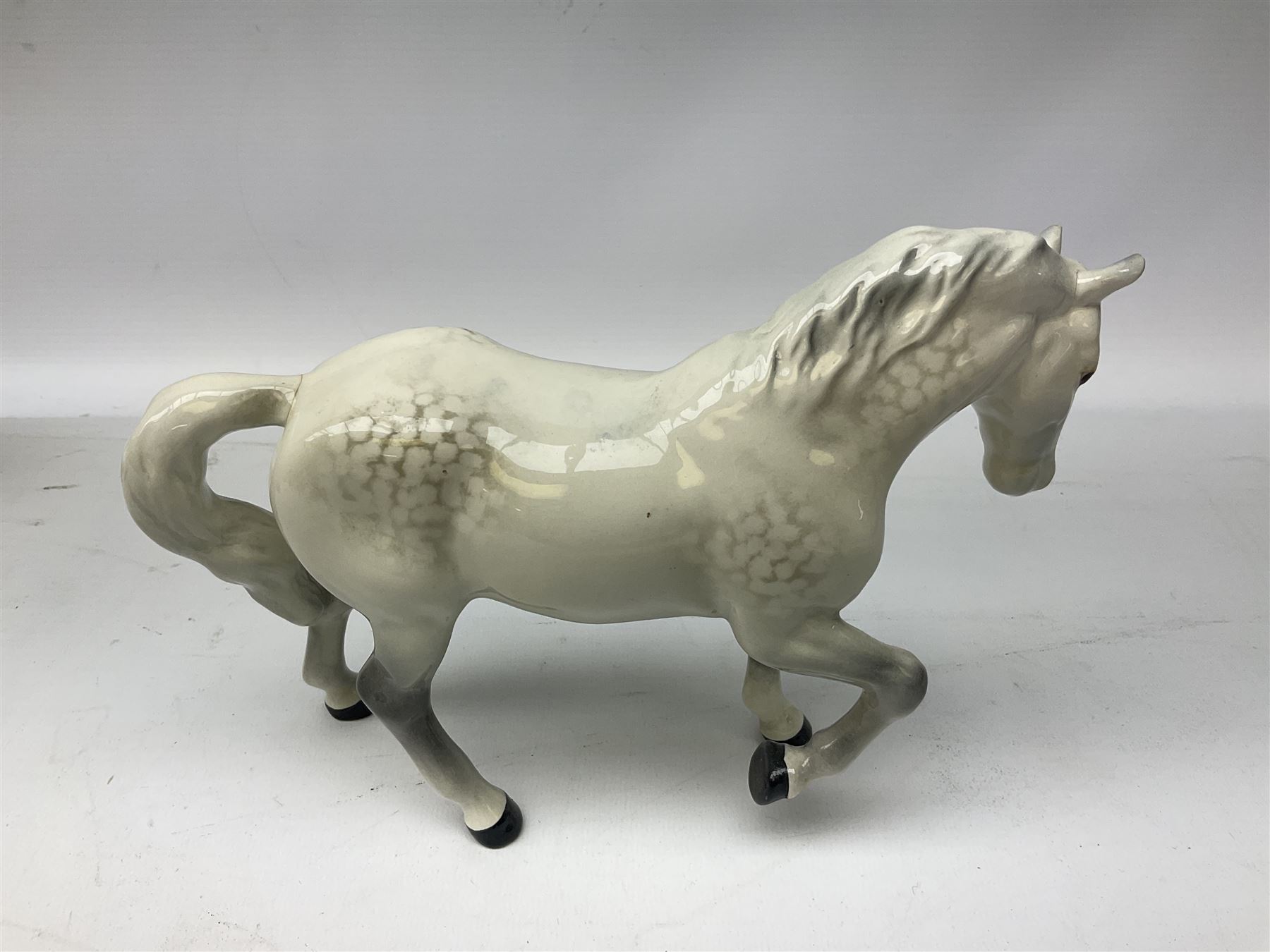 Collection of Beswick horses, including grey horse no.701, palomino foal no 836, grey stocky jogging mare no.855 etc, together two Royal Doulton horses, (8)
