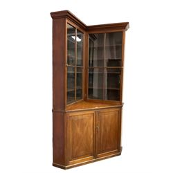19th century mahogany corner bookcase cupboard, projecting cornice over two astragal glazed doors enclosing eight shelves, lower section with two panelled cupboard doors concealing single shelf