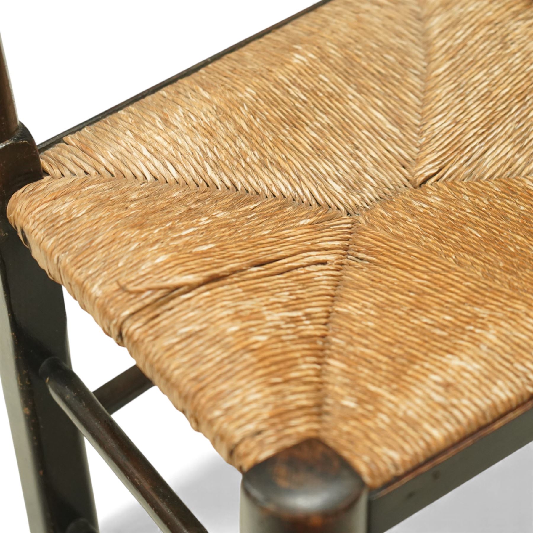 20th century set of five spindle-back dining chairs, with shaped top rails above turned spindle splats, rush seats, turned forelegs united by stretchers