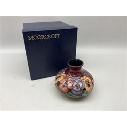 Moorcroft vase, of squat bulbous form, decorated in the Pansy pattern upon a maroon glazed ground, with painted mark beneath, with original box, H11cm