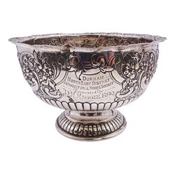 Late Victorian silver rose bowl, of circular form with embossed foliate and C scroll decoration, and engraved personal dedication, upon a part fluted spreading circular foot, hallmarked Wakely & Wheeler, London 1898, H11.5cm D18cm, approximate weight 11.67 ozt (363.2 grams)