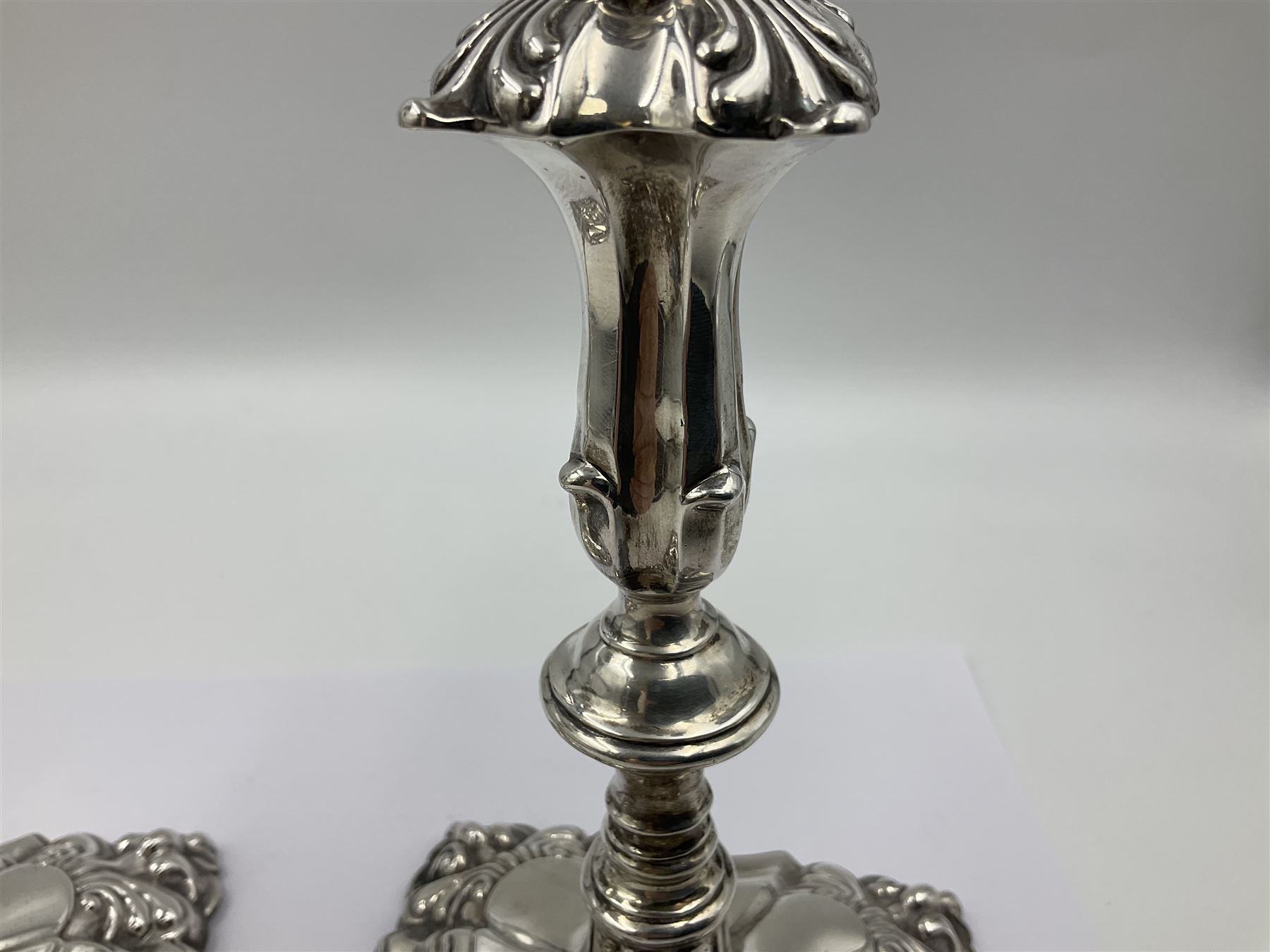Pair of late Victorian silver mounted candlesticks, each of knopped and part fluted form, upon square stepped base with anthemions to each corner, with conforming sconces, hallmarked to removable sconces and foot, Thomas A Scott, Sheffield 1901, H25.2cm