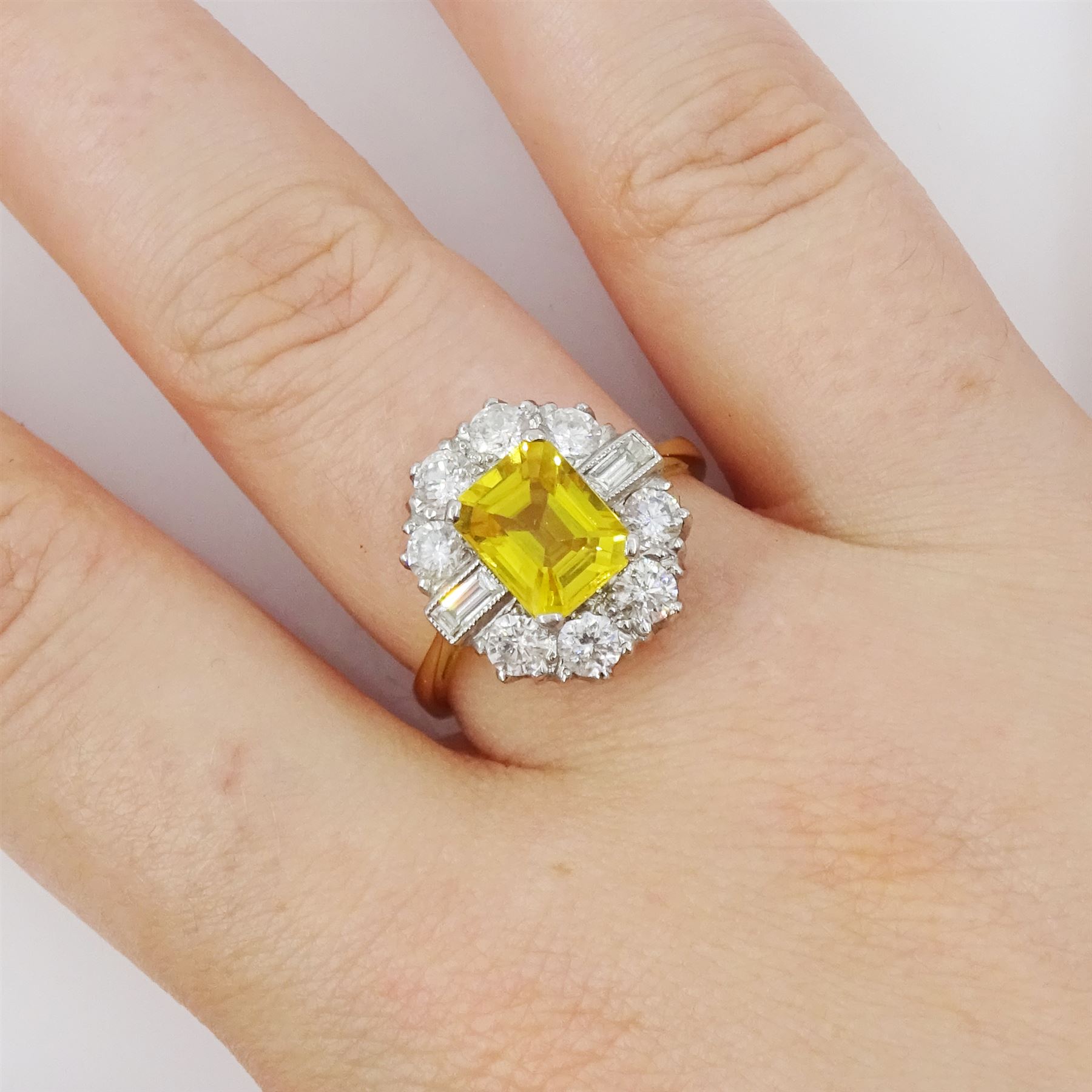 18ct gold yellow sapphire and diamond cluster ring, single octagonal cut yellow sapphire of approx 2.15 carat, surrounded by eight brilliant cut diamonds and two baguette cut diamonds within a milgrain setting, stamped, total diamond weight 1.2 carat