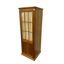 Rustic pine wardrobe, single glazed door with interior curtain enclosing shelf, on castors