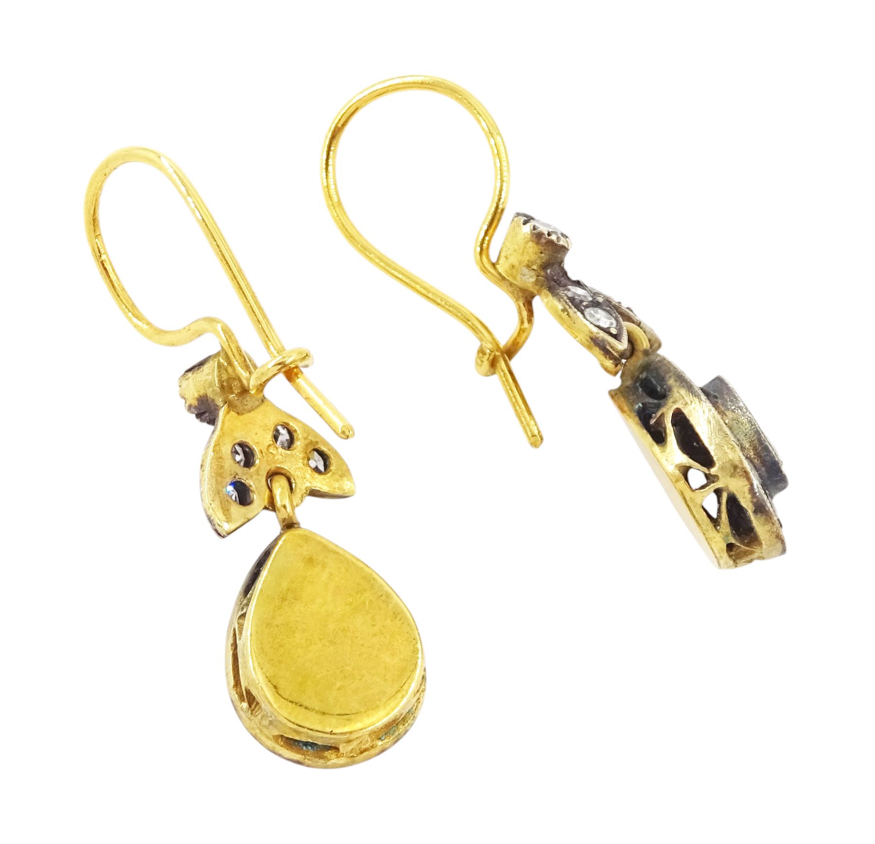 Pair of gold and silver diamond earrings, each pendant with pear shaped drop set with round brilliant cut and single cut diamonds, suspended from a diamond set leaf design bail, total diamond weight approx 1.00 carat