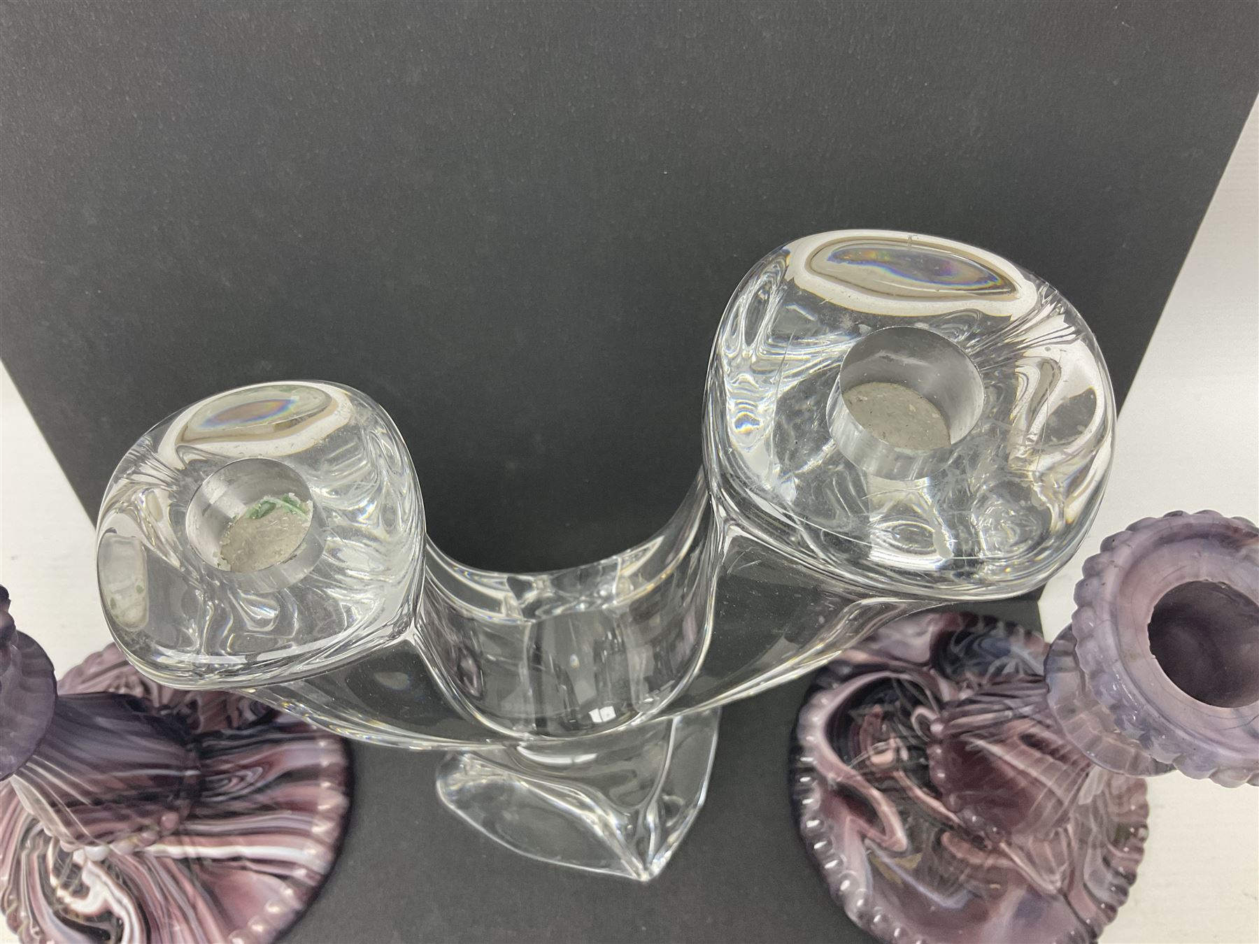 Daum glass two stemmed candle stick signed to verso, together with a pair of slag glass purple candle sticks, Daum H21cm