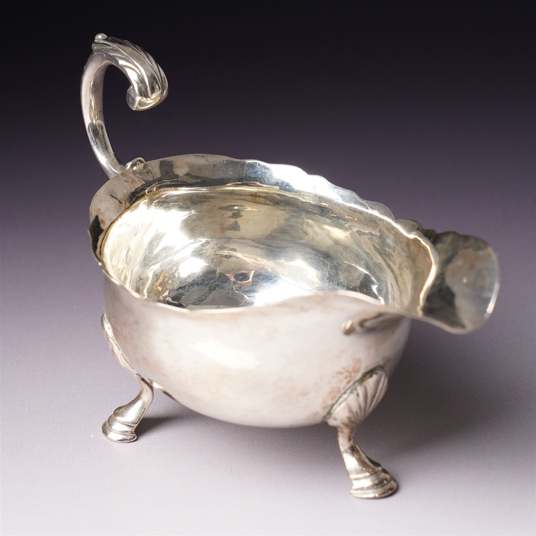 Silver vase shape sugar caster H15cm London 1975 Maker C J Vander Ltd and a George III silver sauce boat with crimped rim and 'C' scroll handle London 1763 Maker possibly William Skeen