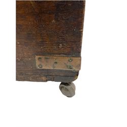 Early 19th century oak low blanket chest, metal strapped and bound, two carrying handles to either end, on castors