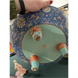 20th century Chinese footed bowl, of circular form, decorated in polychrome enamels with flowers and foliage on a cobalt blue ground, upon three grotesque mounted feet, with character marks beneath, H13cm, D38cm
