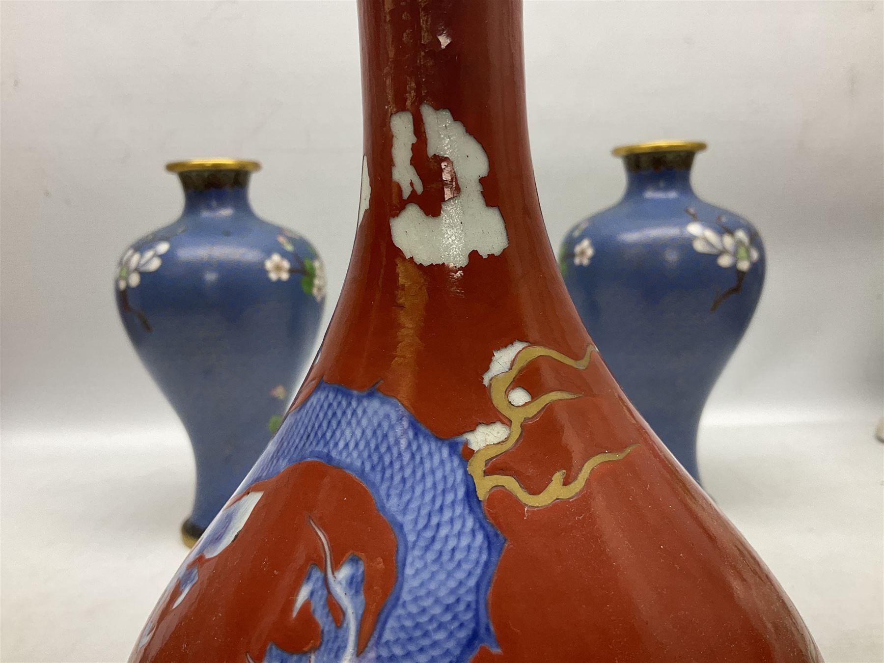 20th Century Japanese vase decorated with a blue dragon and gilding upon red yellow ground, bears Fukagawa Seiji mark (a/f), together with pair of blue cloisonné vases of baluster form decorated with blossom, and pair of Japanese vases, tallest H26cm