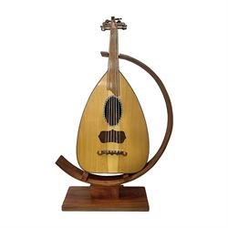 20th century Middle Eastern six string lute with a segmented back and a purpose designed hardwood stand