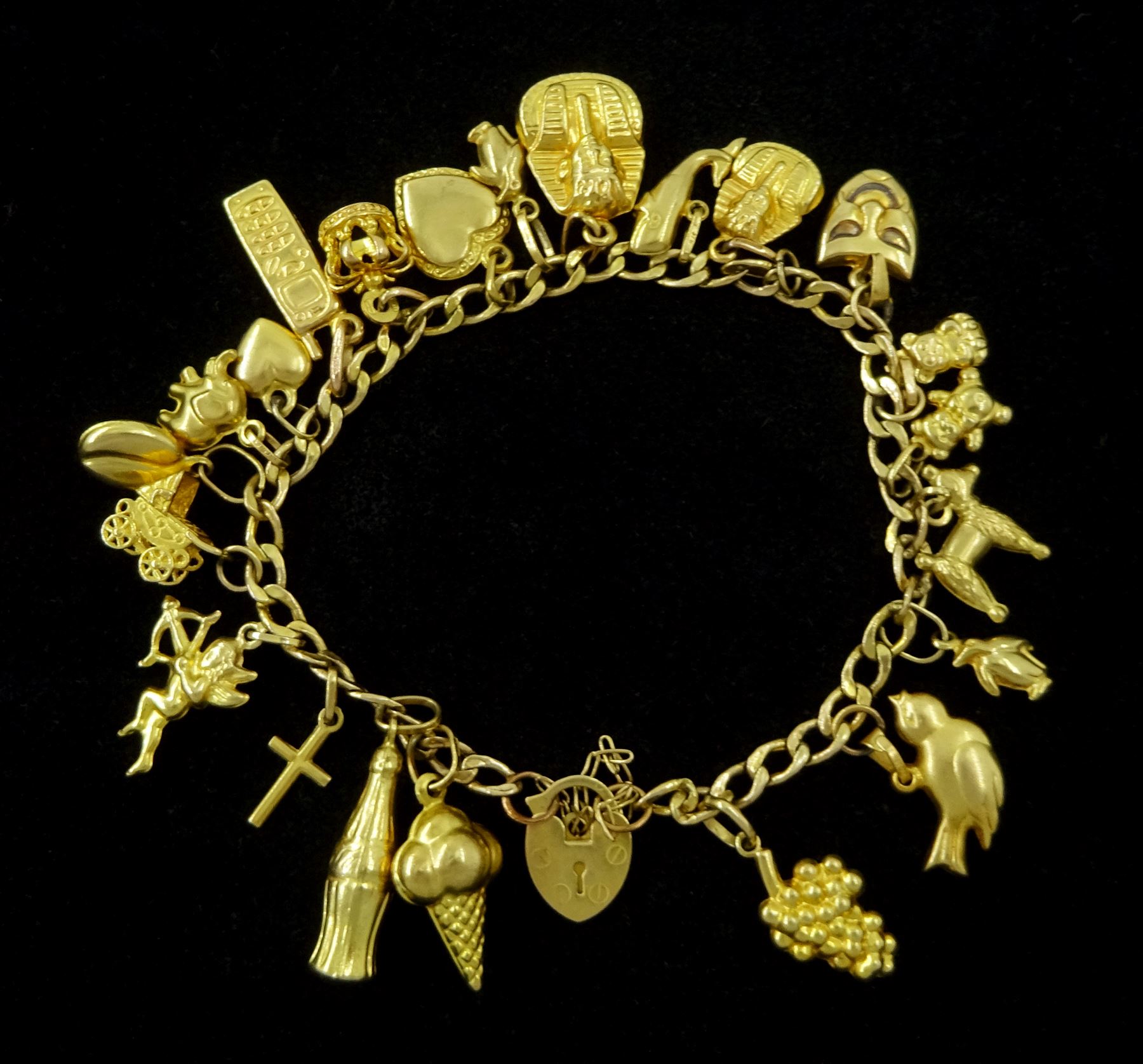 9ct gold charm bracelet including ice cream cone, bird, coca cola bottle, poodle and whale