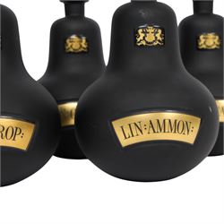Set of four 20th century Royal Pharmaceutical Society black frosted glass bottles, of bellied form with clear cut glass spire stopper, each body bearing gilt label in Latin: LIN:AMMON:, LIN:ATROP:, LIN:CAMPH:, and LIN:CALCi:, and gilt Royal Pharmaceutical Society crest to neck, H25cm

Provenance: From the collection of the family of Peter Green, a practising pharmacist whose career spanned the mid to late 20th century. During his professional life he managed pharmacies in Yeovil, Somerset, and later Selles Chemist in Filey, North Yorkshire, before purchasing and running his own business, Peter Green Pharmacy, located in the Market Place, Malton. The bottles were displayed as part of the traditional shop fittings in both the Filey and Malton pharmacies and were retained as part of his collection.