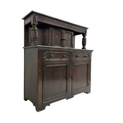 20th century oak court cupboard, arcade carved frieze over baluster supports with demi-hexagon cupboard with lozenge carved facias, the base fitted with two drawers over double cupboard, each with heavily moulded edges