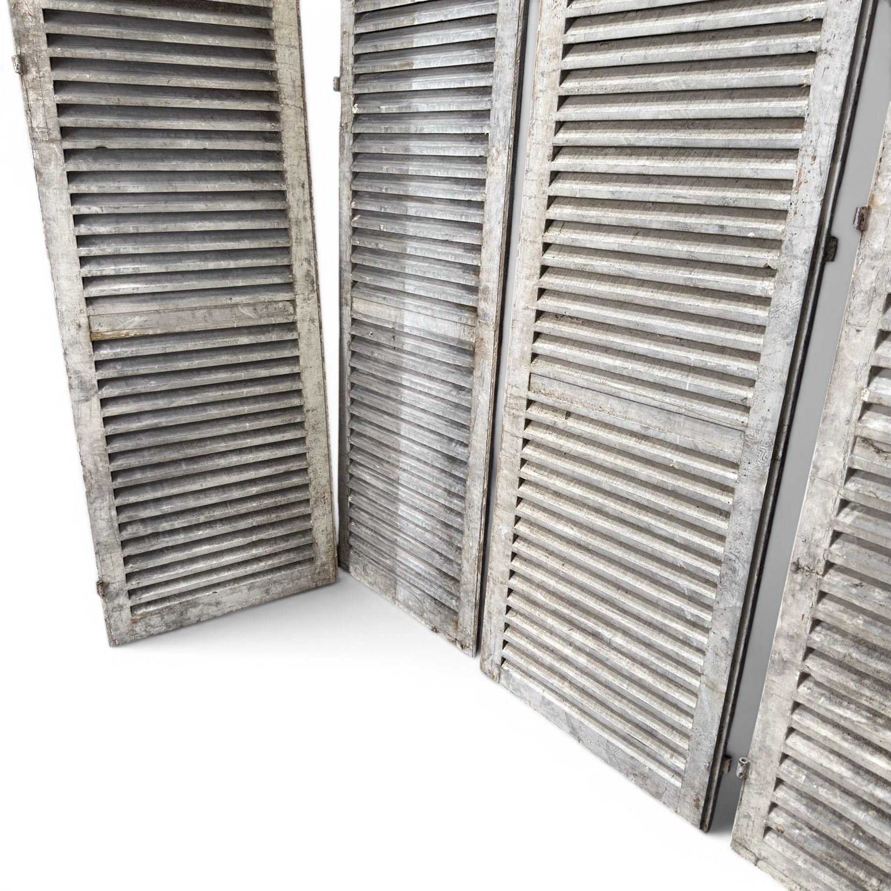 Five 19th century full height French Chateau louvre doors, pitch pine painted in cream finish, two having iron rod hinges, dimensions approx.