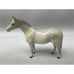 Collection of Beswick horses, including grey horse no.701, palomino foal no 836, grey stocky jogging mare no.855 etc, together two Royal Doulton horses, (8)