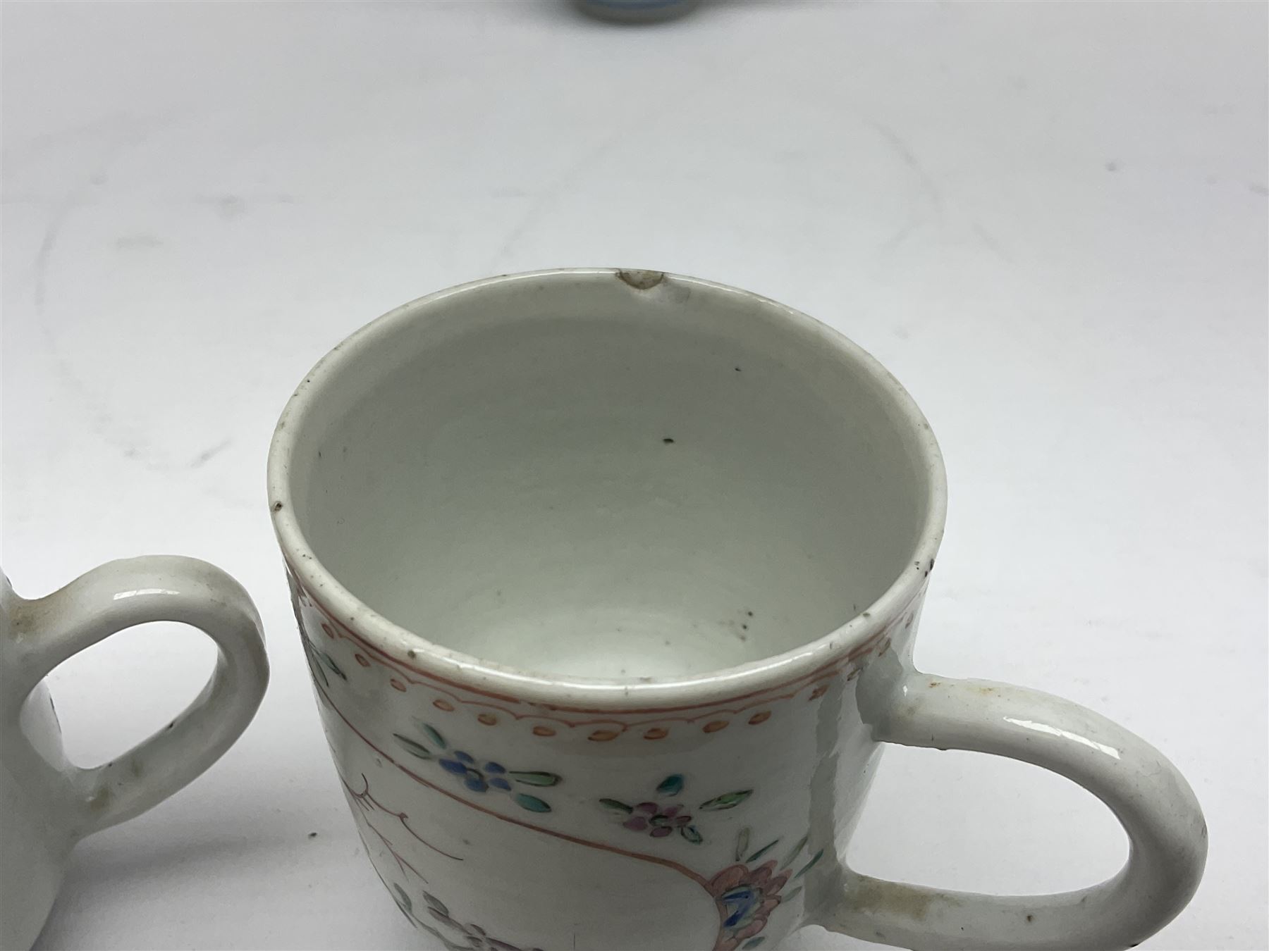 Two 18th century Chinese Yongzheng coffee cups, the first example decorated in polychrome enamel with rooster amidst blossoming peonies, the second decorated with deer and crane among rockwork and pine tree, together with two further 18th century Chinese coffee cups, an 18th century Chinese tea bowl, and a further tea bowl