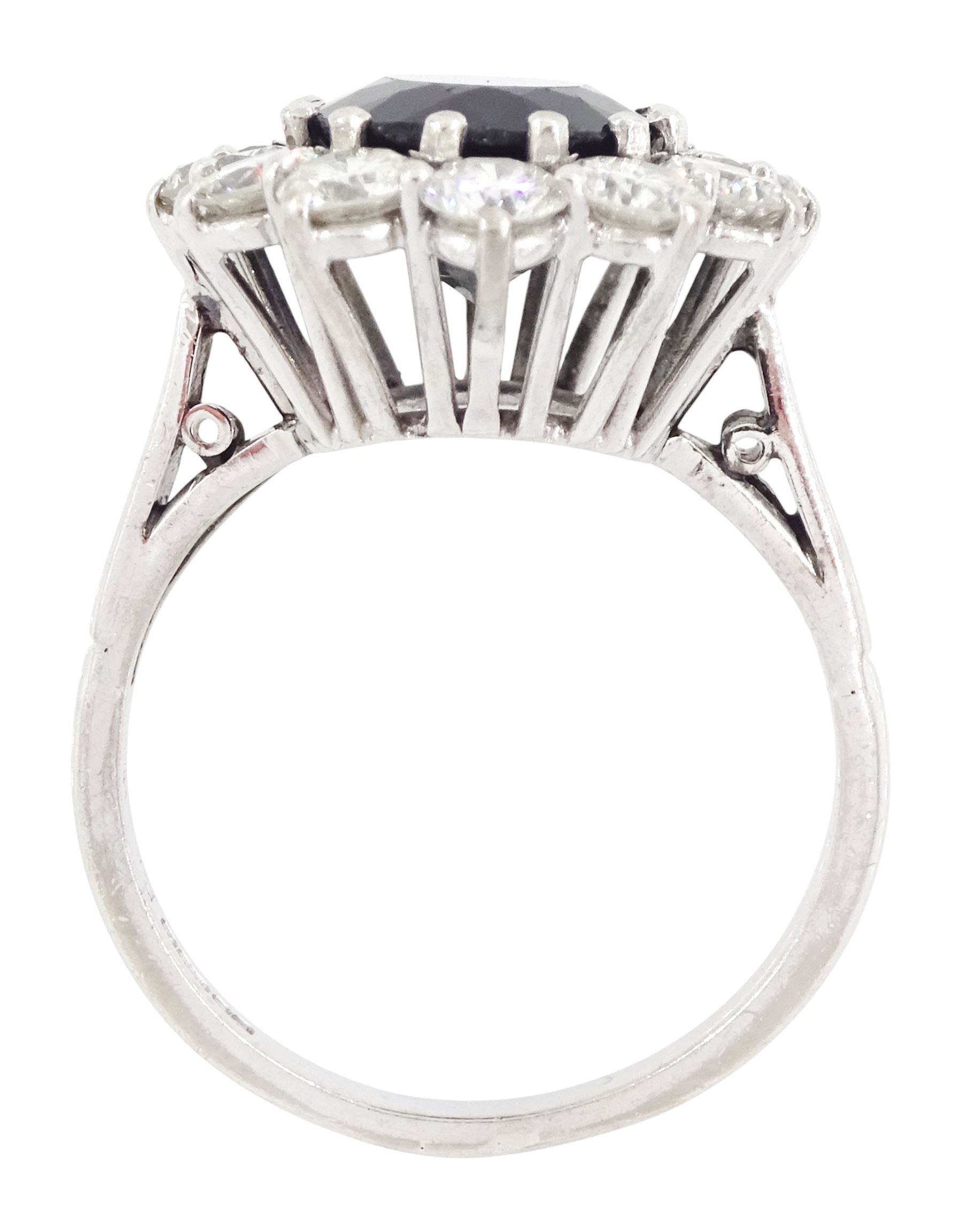 18ct white gold sapphire and diamond cluster ring, single oval cut sapphire of approx 4.50 carat, surrounded by twelve brilliant cut diamonds, Birmingham 1982, total diamond weight approx 2.65 carat