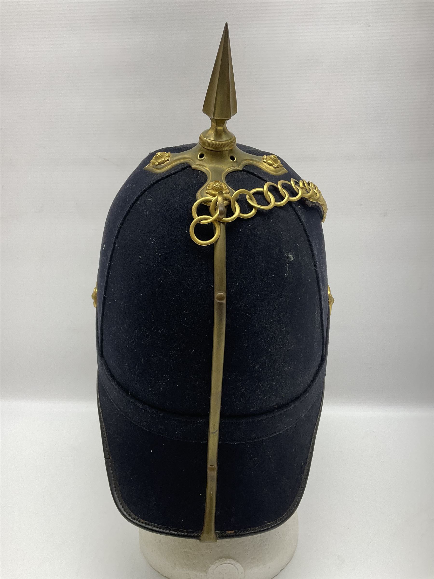 Post-1902 Welsh Regiment Officer's Home Service Blue Cloth Helmet with gilt metal King's crown helmet plate to the front, a removable spike to the top on a shaped cruciform base with rosette fittings, rosette side bosses, brass trim to the front peak, and leather and velvet backed chin scales, with sweat band, the interior with the remains of a makers label at the address 1,3 & 5 Lexington Street, Golden ? London W (presumably Hobson & Sons)