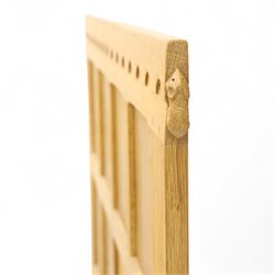 Mouseman - single bed oak headboard, comprising eight vertical fielded panels beneath a shaped and scalloped top rail, carved with the signature mouse motif, by the workshop of Robert Thompson, Kilburn 