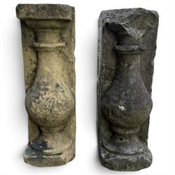 Pair of George III weathered carved sandstone architectural corbels, each with a projecting moulded capital above a half-canted baluster, waisted socle and stepped base