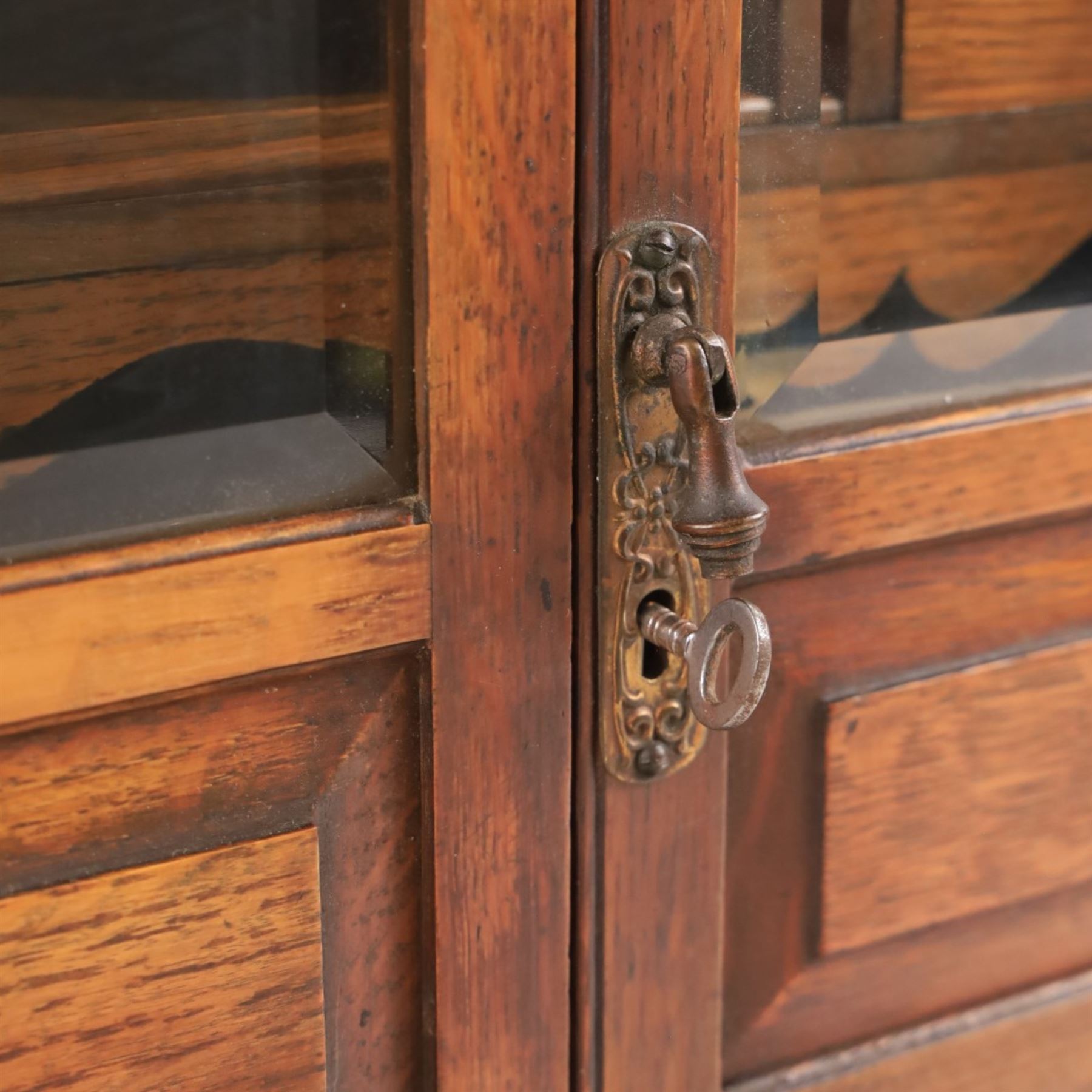 19th century oak table top smokers cabinet, with carved foliate pediment, the two beveled edge glass doors opening to reveal a fitted interior, with four drawers and fitted brass of pipe holders to each door, H46cm