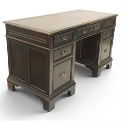 Titchmarsh & Goodwin style desk, rectangular top with inset red leather writing surface, central frieze drawer flanked by three drawers, pedestals fixed to the top, raised on bracket feet 
