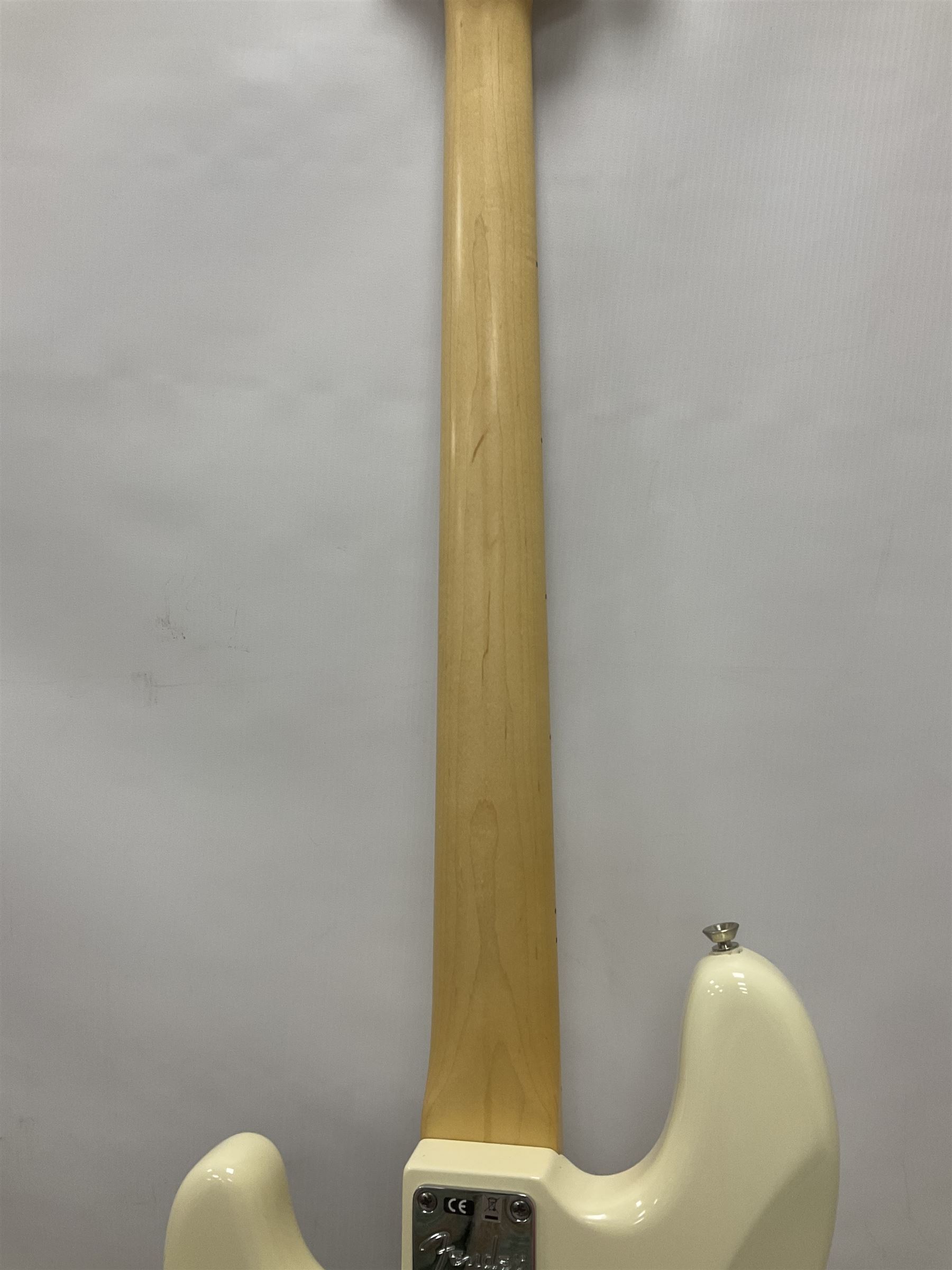 Fender Precision Bass guitar, in Olympic White finish with tortoiseshell effect scratchboard, serial no US15103092, in black Fender hard case with Fender strap and warranty card, guitar L116cm
