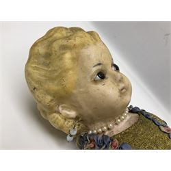 Victorian large wax over composition Pumpkin head doll, with inset dark glass eyes, moulded blonde hair in curls, stuffed body with carved and painted wooden limbs, grey painted boots, floral satin dress with netting underclothes H61cm