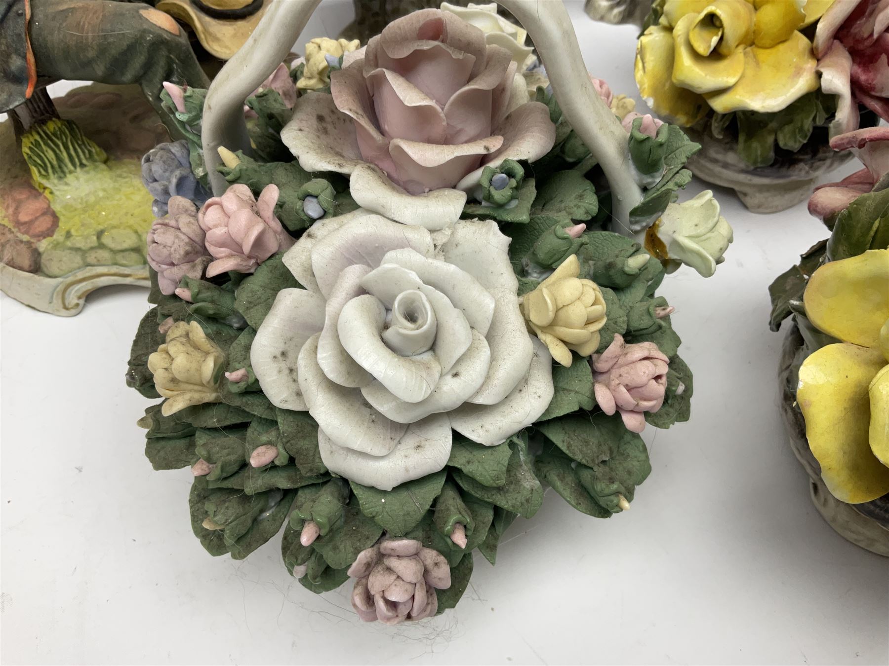 Two Royal Doulton cats, two Capodimonte style figures, and four ceramic baskets of flowers 