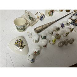 Three hallmarked silver thimbles, a hallmarked silver handled button hook, crested ware including items by W.Goss, miniature oriental style tea set and a collection of ceramic souvenir thimbles