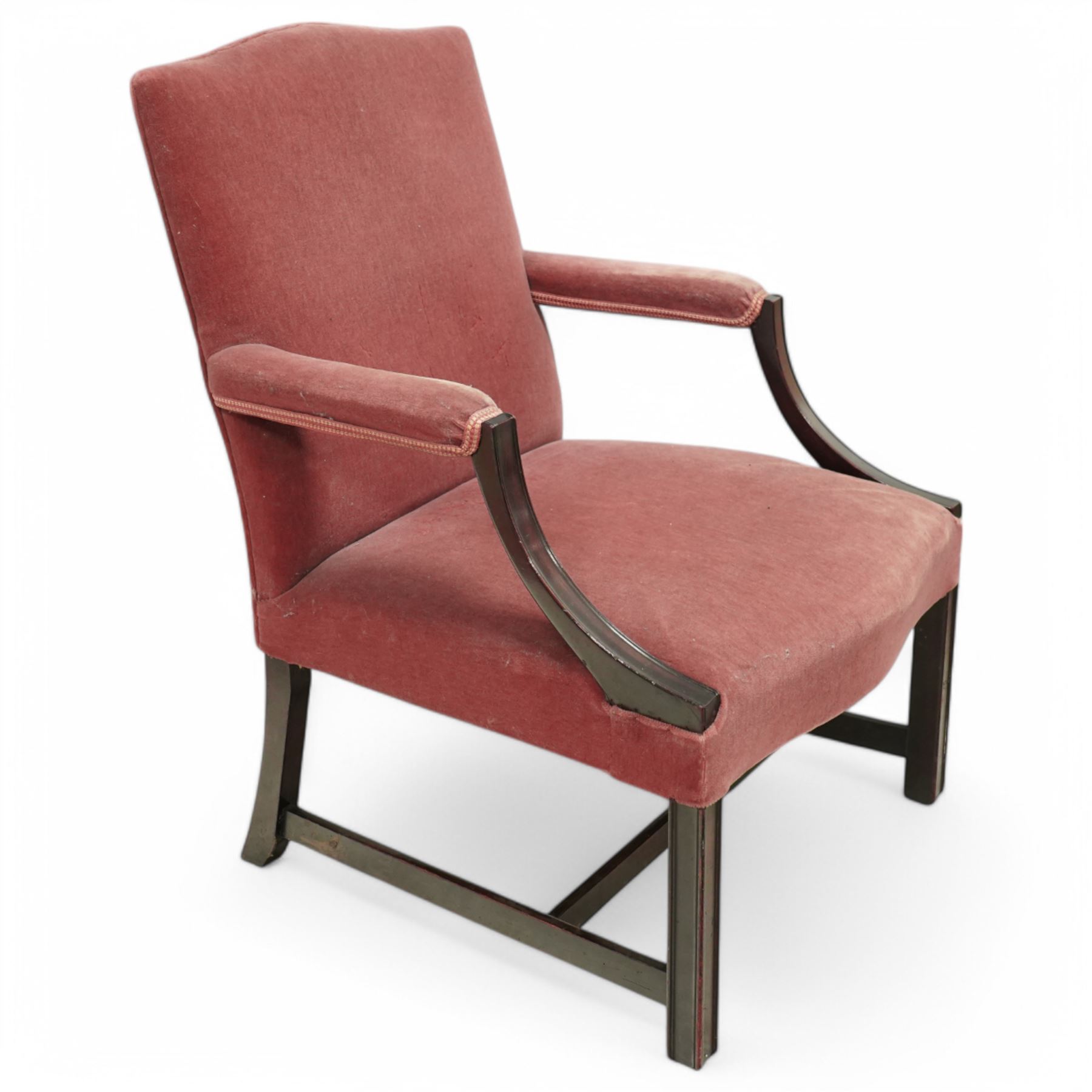 Georgian design mahogany Gainsborough chair, upholstered in pink fabric, curved and moulded arm supports, on moulded square front supports united by H-stretchers 