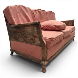 Early 20th century French style bergère conservatory suite, canework back and sides with red upholstered loose seat cushions, on cabriole feet