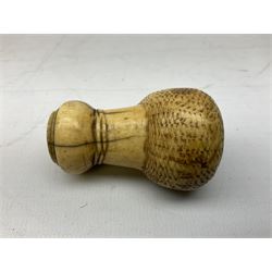 19th century carved ivory walking cane handle, modelled as the head of a greyhound with inset glass eyes, together with a further 19th century ivory example, modelled as a caricature of a gentleman's head, (2)