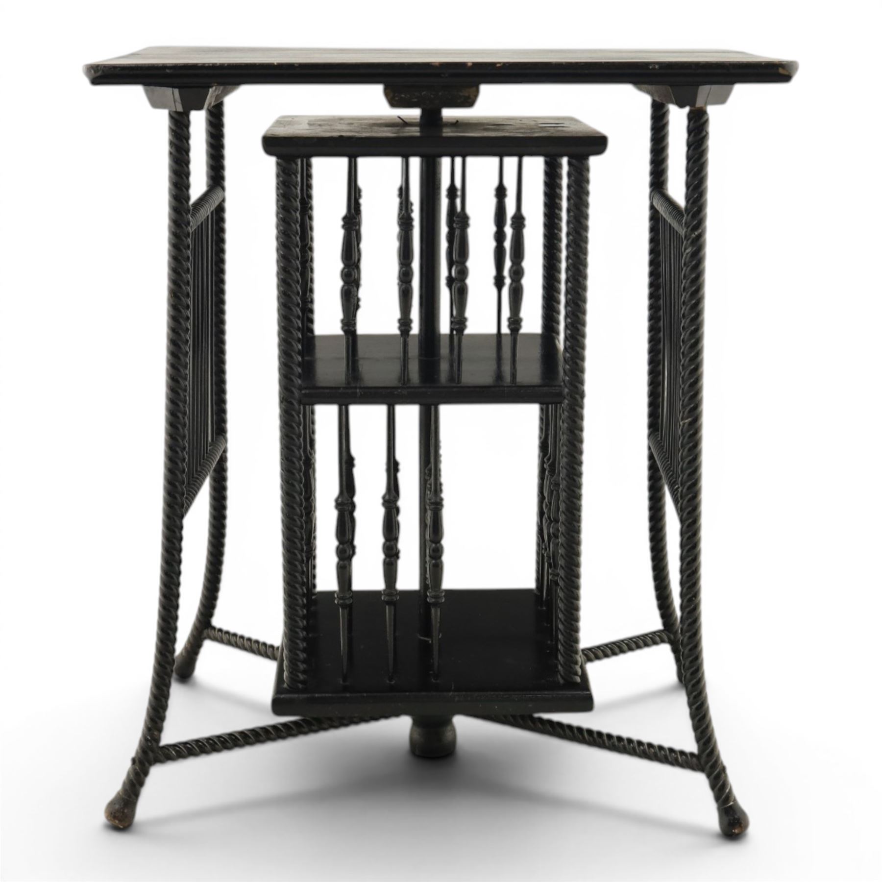 Edwardian black painted side table with incorporated revolving bookcase, supported on barley twist legs