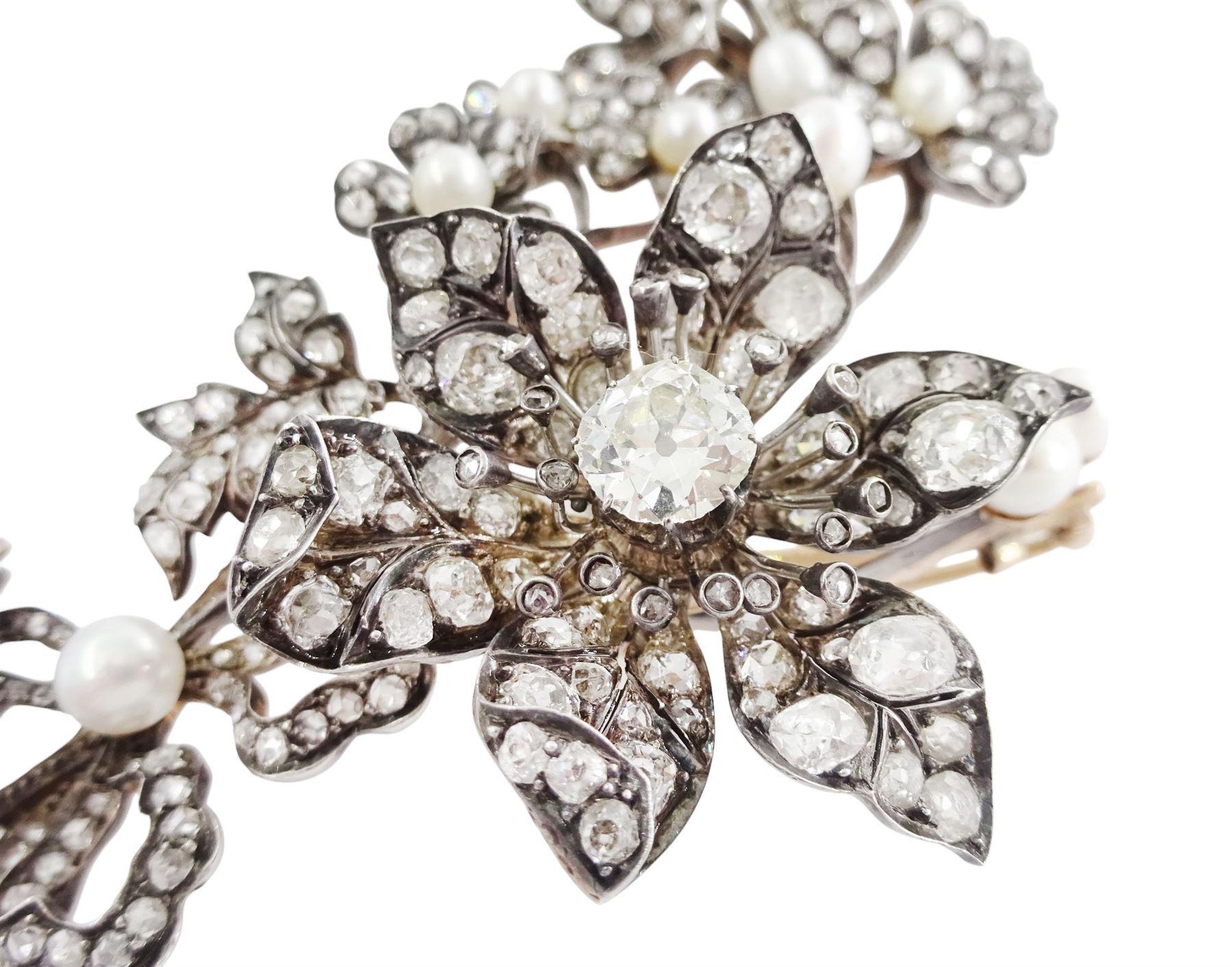 19th century gold and silver diamond and pearl en tremblant detachable brooch, the flower tremblant with a principal old cut diamond of approx 1.90 carat, the petals and stamen set with old cut and rose cut diamonds, total diamond weight approx 9.10 carat, to a foliate spray set set with further rose cut diamond and white / pink / cream pearls and ribbon tie