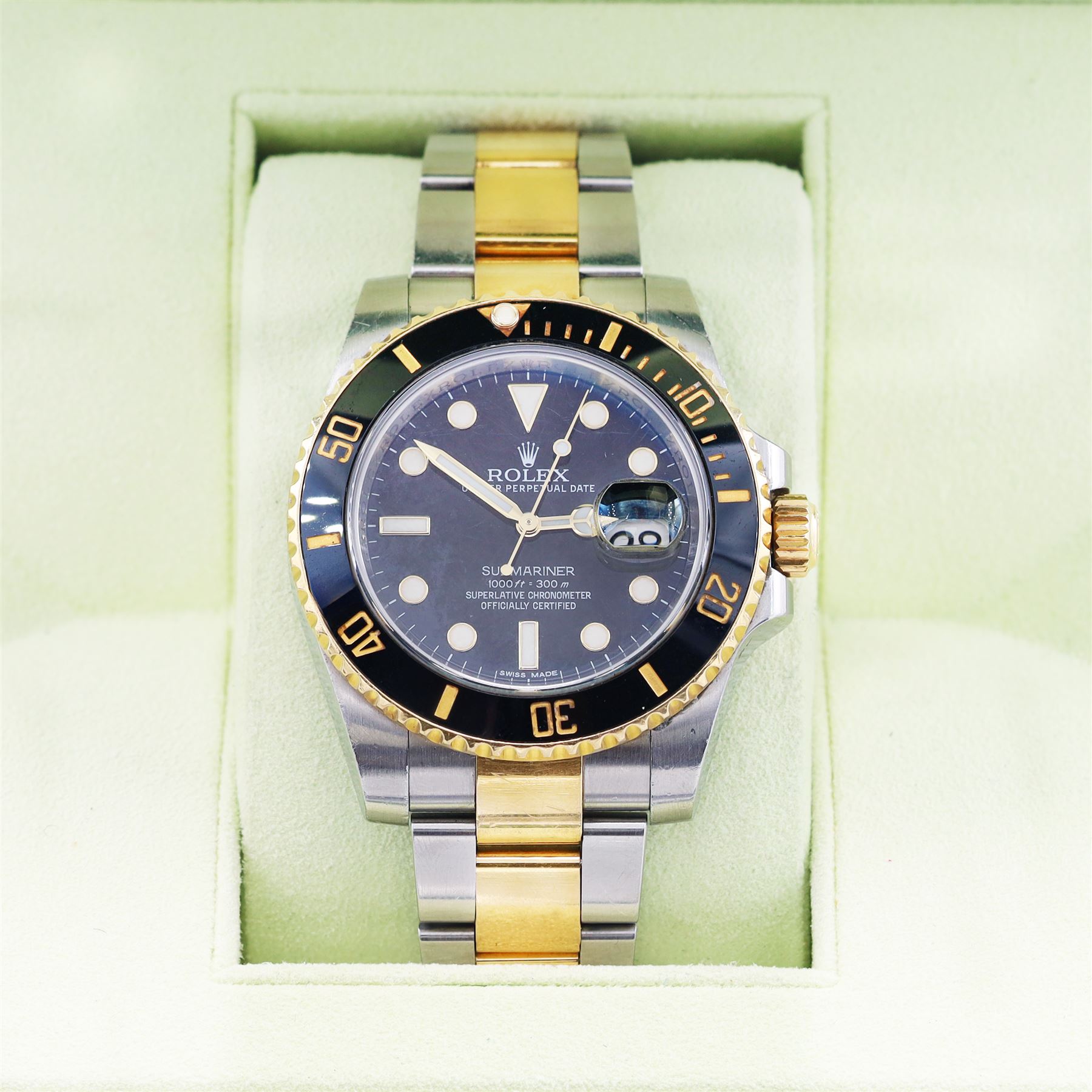 Rolex Oyster Perpetual Submariner Date gentleman's stainless steel and gold automatic wristwatch, Ref. 116613LN, serial No. 8201P7C5, back dial with luminous hour markers, unidirectional rotating black ceramic bezel, on stainless steel and yellow gold Rolex Oyster bracelet with fold-over clasp, boxed with guarantee card dated 2013