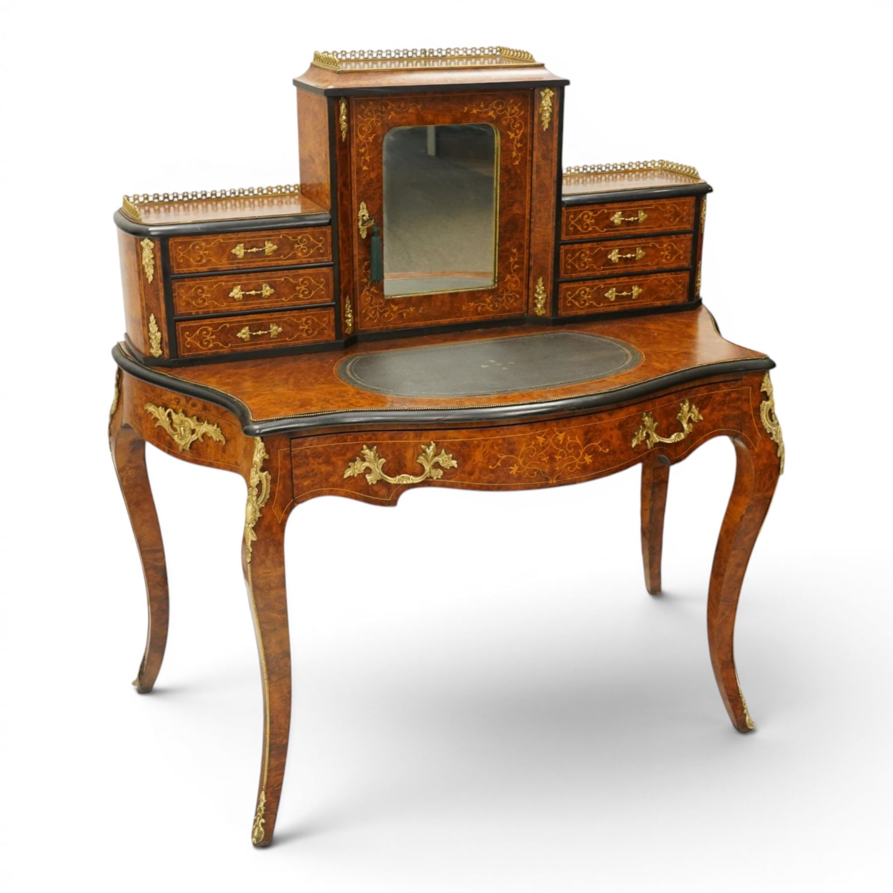 19th century French inlaid figured walnut and ebonised Bonheur de Jour or writing desk, the raised upper section with pierced brass three-quarter gallery, over a mirror glazed cupboard and a combination of drawers, the shaped and moulded top with leather inset and satinwood stringing, with brass beading too the ebonised edge, fitted with a serpentine fronted frieze drawer, raised on cabriole supports, inlaid throughout with scrolling foliate decoration in boxwood and ornate cast brass mounts and handles