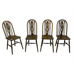 Set of four elm and beech Windsor design dining chairs, hoop and stick back with wheel splat, on turned supports united by H-stretchers 