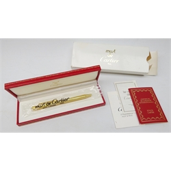  Cartier: Stylo Bille Must II ballpoint pen with reeded gold plated body, serial number 138071, in original sealed wrapping, with certificate, guarantee and instructions in original box with outer box  