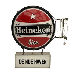Heineken Bier Advertising sign - circular convex backlit logo, on cast metal bracket, with 'De Nije Haven' text below