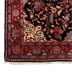 Two hand-knotted rugs, comprising Persian floral rug, dark blue ground decorated with scrolling foliage and flowerheads within a red floral border (H 208cm, W 134cm); Bokhara type rug, red ground with repeating gul motifs and geometric guard borders (H 174cm, W 94cm)